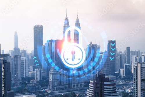 Padlock icon hologram over panorama city view of Kuala Lumpur to protect business  Malaysia  Asia. The concept of information security shields. Double exposure.