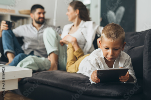 young happy family at home . boy using tablet computer