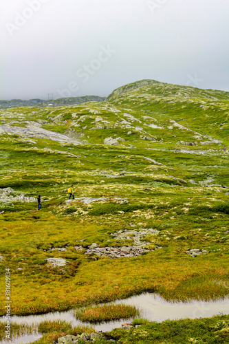 Hikers on the Hydnefossen waterfall and Hydna river in Hemsedal. photo