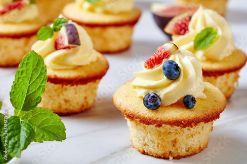 Wallpaper Mural cupcakes with buttercream and berries on a table Torontodigital.ca