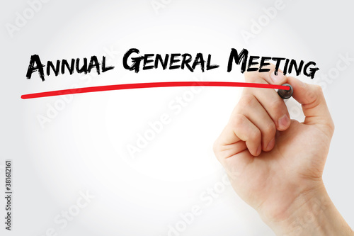 Annual General Meeting text with marker, business concept background photo