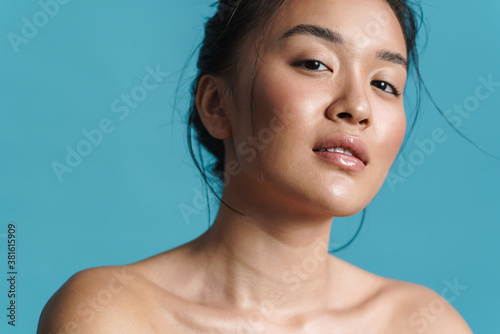Image of shirtless asian girl posing and looking at camera