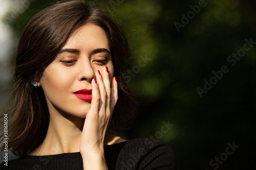 Fashion portrait of a tender woman with red lips