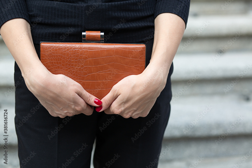 Woman in black apparel holding purse