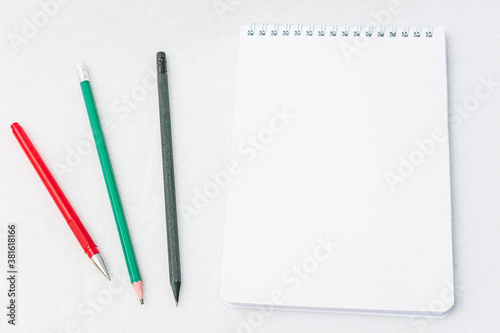 Notebook and pencil, pen, white background, top view, copy space