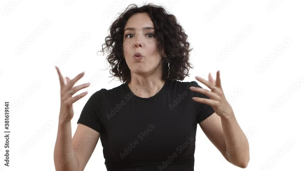 Close-up of pretty adult female model with short dark hair, wearing black t-shirt, looking surrpised and then impressed with person story, standing over white background