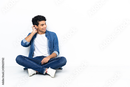 Venezuelan man sitting on the floor thinking an idea © luismolinero