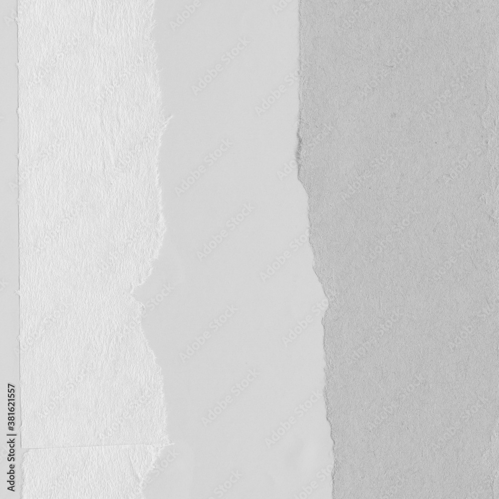 White torn paper collage close-up. Texture made from various paper and cardboard parts. Damaged old paper background. Vintage blank wallpaper. Material design backdrop.