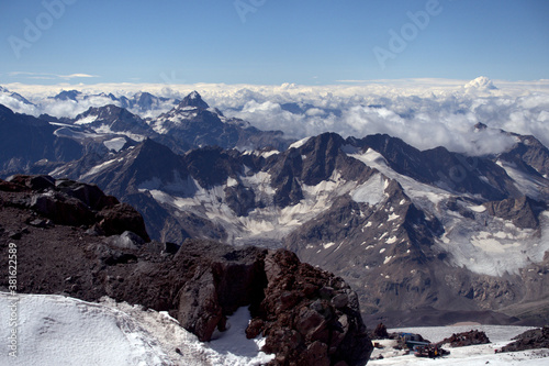 Climbing Elbrus. A view from the slopes of Elbrus to the surrounding mountain peaks covered with snow.