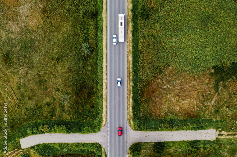 Aerial view of three cars and passenger bus on the road