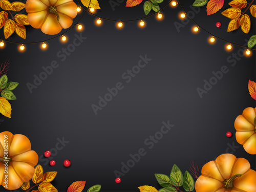 Аutumn leaves with pumpkins, holiday lights on blackboard. Seasonal and holidays concept for advertising, invitation, greeting card photo