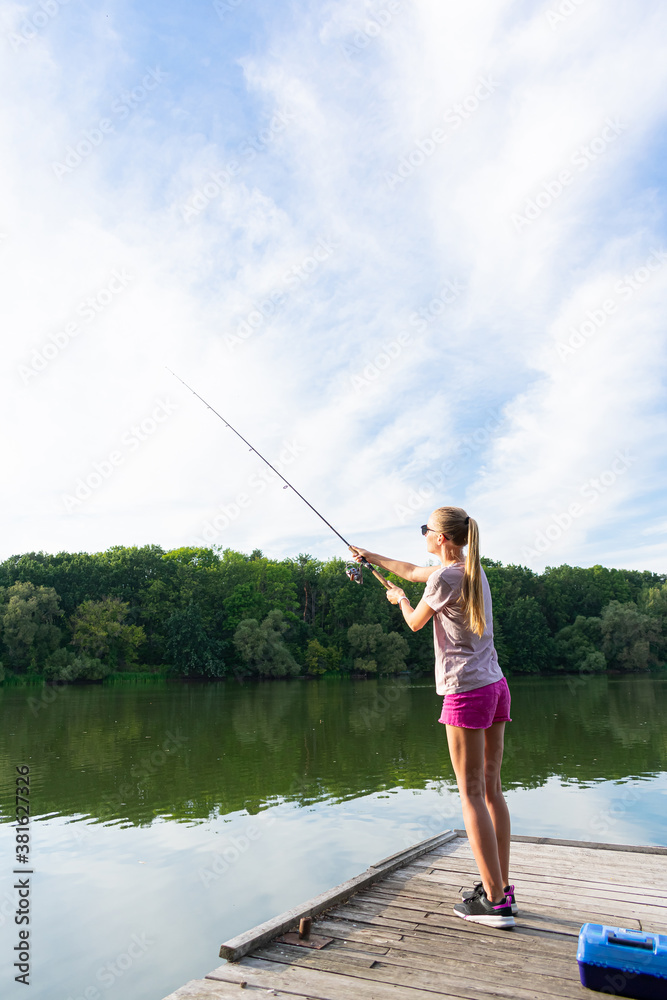 Pretty woman fishing. Fishing on the river