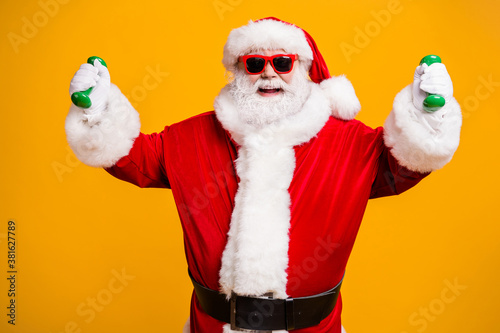 Portrait of his he nice attractive cheerful cheery glad Santa doing workout weight loss activity pilates crossfit isolated bright vivid shine vibrant yellow color background