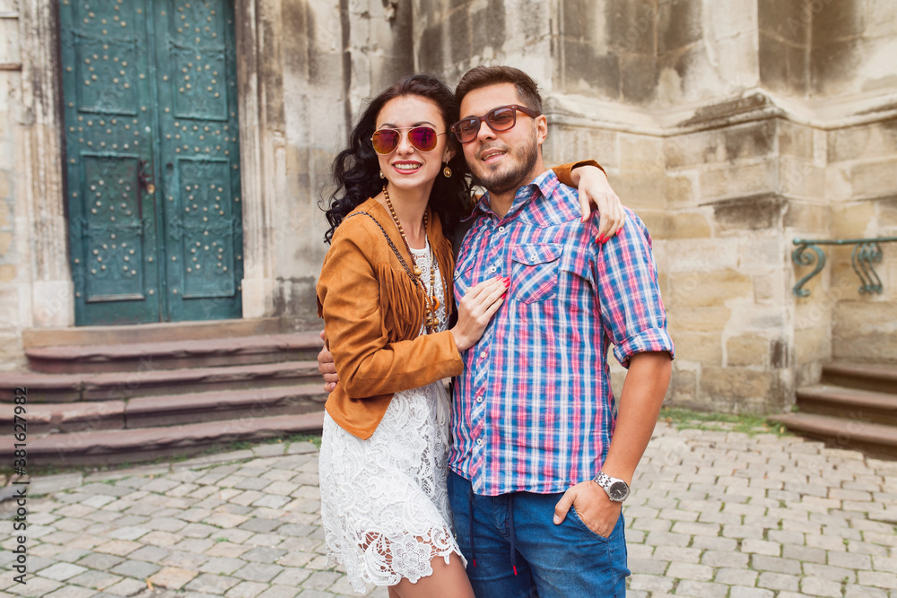 young couple in love traveling, vintage style, europe vacation, honey moon, sunglasses, old city center, happy positive mood, smiling, embracing