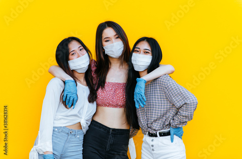 Group of asian girls going out after quarantine during coronavirus period. Young women outdoor with safety masks