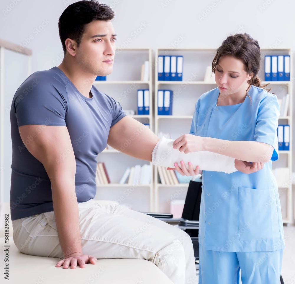 Doctor and patient during check-up for injury in hospital Doctor and patient during check-up for injury in hospital