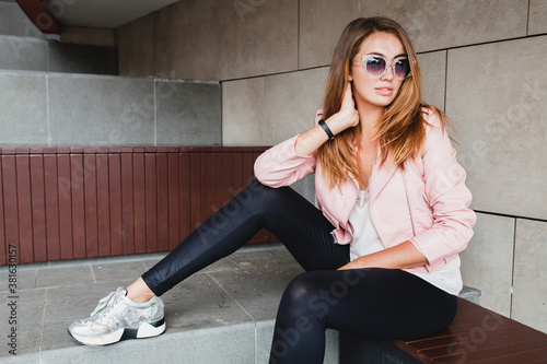 young beautiful stylish hipster woman in pink leather jacket, glam rock style, summer trend outfit, sunglasses, positive mood, happy, smiling, sexy