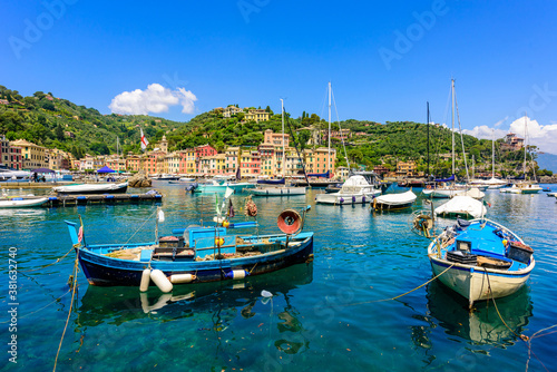 Portofino, Italy - Harbor town with colorful houses and yacht in little bay. Liguria, Genoa province, Italy. Italian fishing village with beautiful sea coast landscape in summer season.