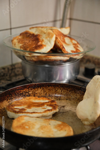 Pan-fried pastry. Baking pastry in the pan. Turkish pastry type bagel "pişi" ready to cook