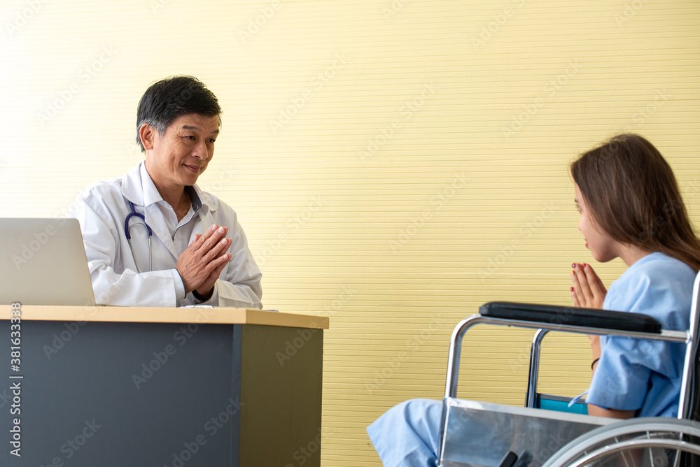 Doctor And Patient Discussing While Sitting At Hospital