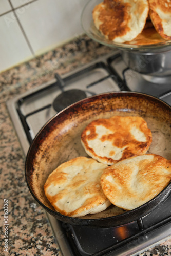 Pan-fried pastry. Baking pastry in the pan. Turkish pastry type bagel "pişi" ready to cook