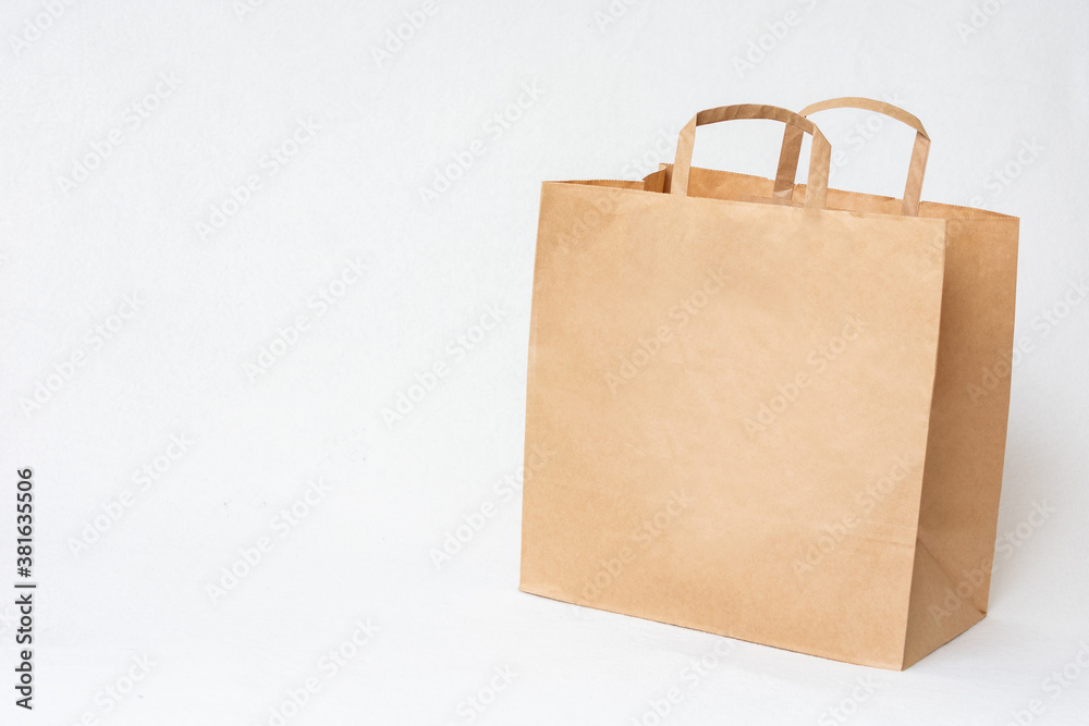 Paper craft bag, white background, side view, copy space Paper craft bag, white background, side view, copy space