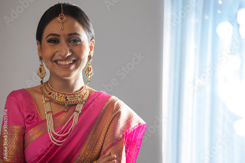 Beautiful bride in a pink saree smiling	
