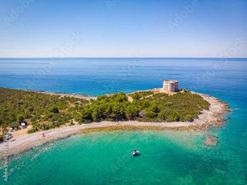 The ancient fort Arza at the entrance to the Bay of Kotor in Montenegro, in the Adriatic Sea, on the peninsula of Lustica. Fortress for military defense. Aerial photo from the drone. photo