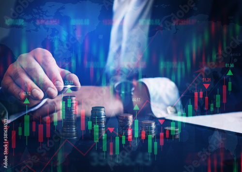 Businessman holding coin with graph. Double exposure of financial graph.Technical price candlestick chart graph and indicator stock online trading. Forex investment business.