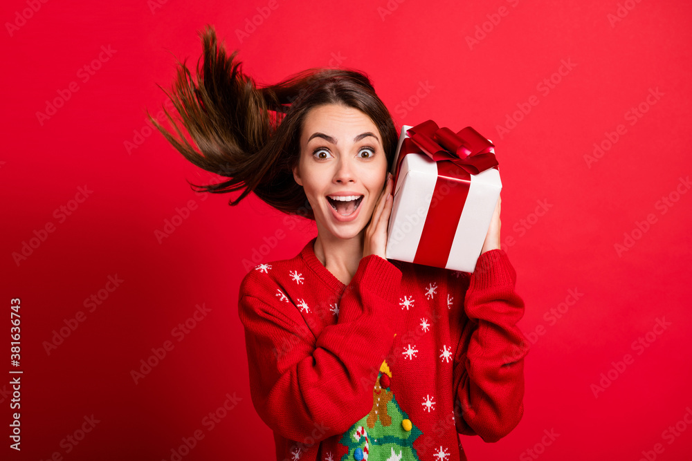Close-up portrait of her she attractive glad cheerful amazed girl holding in hands festal gift celebratory having fun christmastime Eve Noel isolated bright vivid shine vibrant red color background Close-up portrait of her she attractive glad cheerful amazed girl holding in hands festal gift celebratory having fun christmastime Eve Noel isolated bright vivid shine vibrant red color background