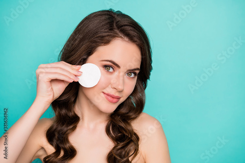 Closeup photo of beautiful charming naked lady curly wavy hairdo hold cotton disk pad removing makeup facial skin enjoy micellar water effect isolated teal color background