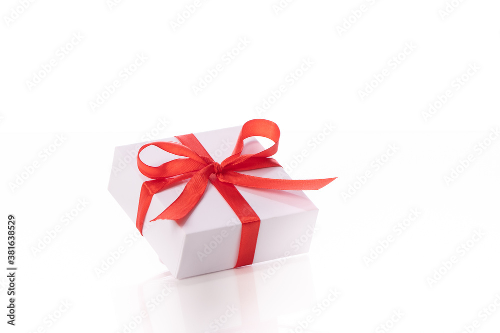 Beautiful white gift box with red bow isolated on white background. Presents, surprise, valentine's holiday congratulations, store promotion, marriage proposal, greeting banner concept. Copy space Beautiful white gift box with red bow isolated on white background. Presents, surprise, valentine's holiday congratulations, store promotion, marriage proposal, greeting banner concept. Copy space
