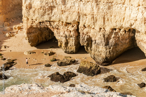 Rock arch by the beautiful sandy beach in Portugal.