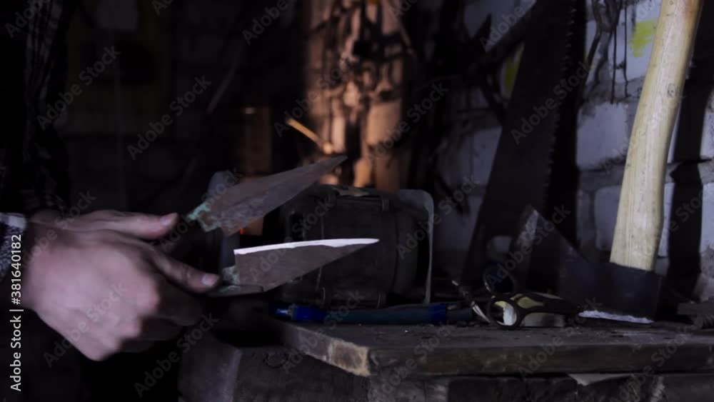 Close-up of a man sharpens a sicator on a grinder sharpener. copy space Close-up of a man sharpens a sicator on a grinder sharpener. copy space