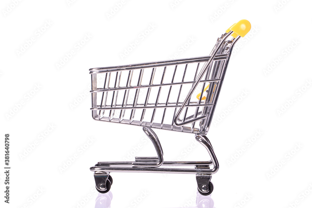 Shopping concept. empty toy shopping trolley isolated on white background side view. Idea for discount, e-commerce, online shopping, sale. Symbol of consumer society. Purchase concept Shopping concept. empty toy shopping trolley isolated on white background side view. Idea for discount, e-commerce, online shopping, sale. Symbol of consumer society. Purchase concept