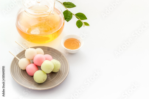 Japanese food background with sweets and tea. Three colored dumplings Dango