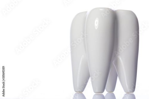 Fototapeta Naklejka Na Ścianę i Meble -  Large healthy looking ceramic 3D tooth model isolated on white background. Oral care, personal hygiene, oral cavity, dental equipment, morning routine. Copy text space, dental poster concept