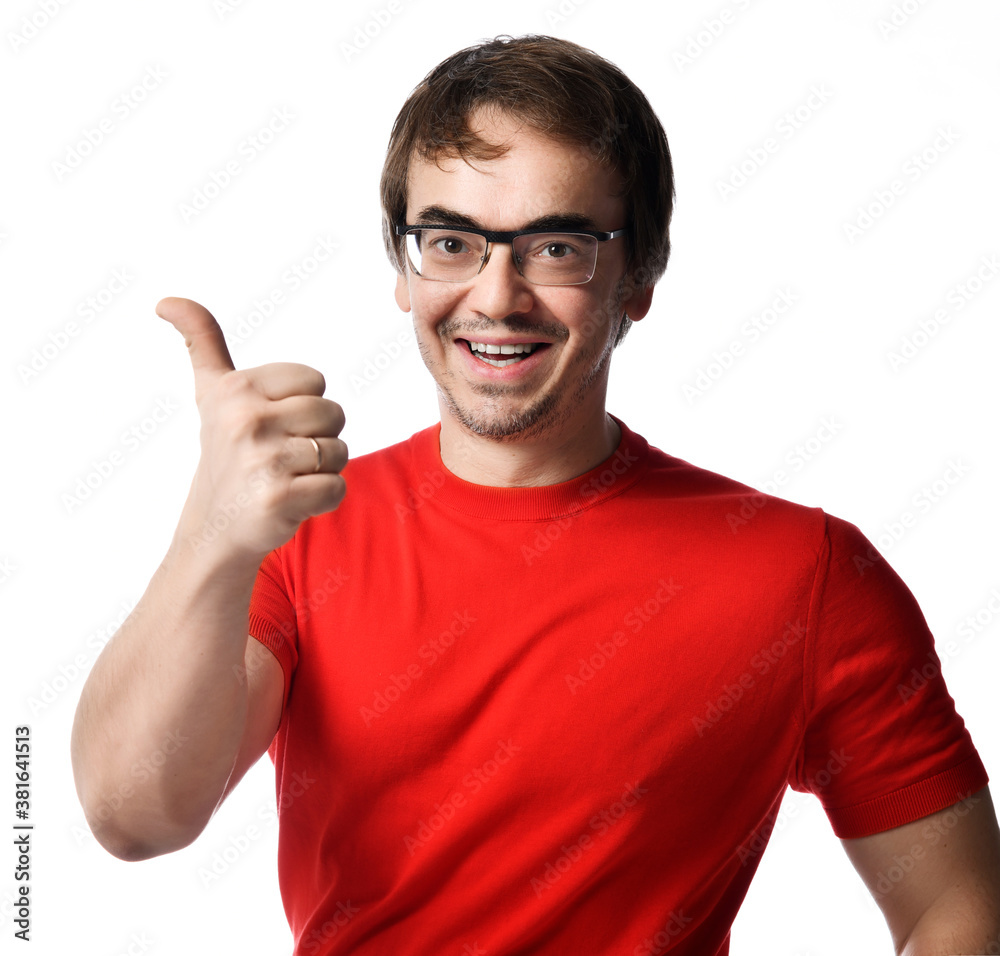 Portrait of smiling adult man in glasses and red t-shirt gesturing thumbs up sign over white background. Expressing Portrait of smiling adult man in glasses and red t-shirt gesturing thumbs up sign over white background. Expressing