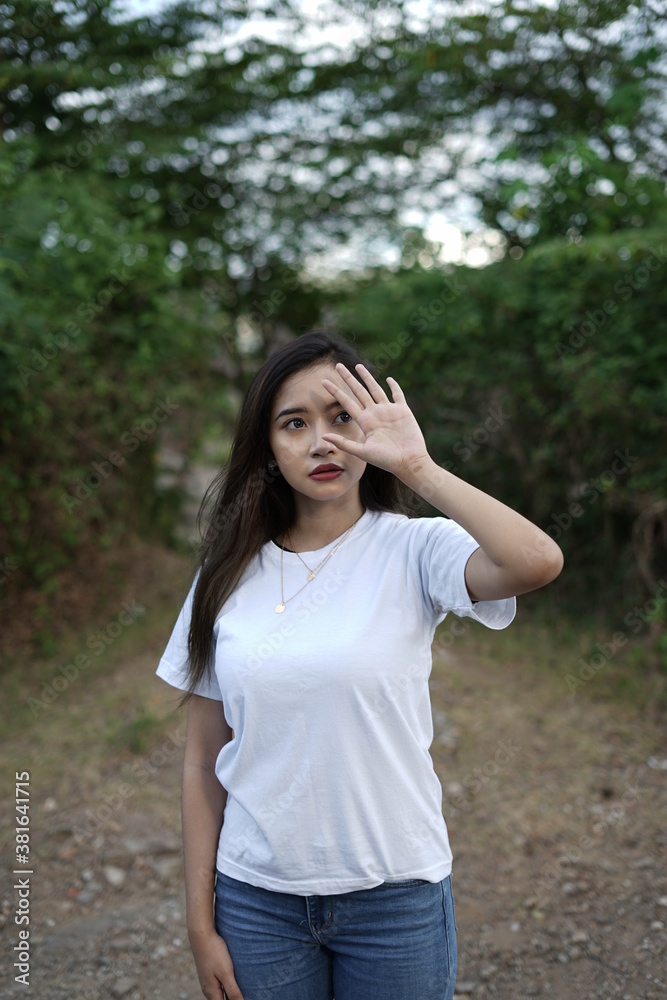 a stylish young woman wearing a white T-shirt against the backdrop of a forest view. black t-shirt models for mockups and templates. a stylish young woman wearing a white T-shirt against the backdrop of a forest view. black t-shirt models for mockups and templates.