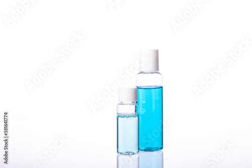 set of small hand sanitizers for personal hygiene. two Personal sprayers for disinfection. Coronavirus Pandemic Control. Transparent and blue alcoholic disinfectant solution.