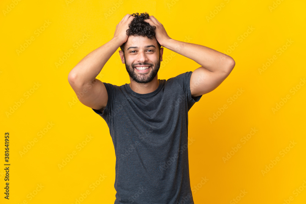 Young Moroccan man isolated on yellow background laughing Young Moroccan man isolated on yellow background laughing