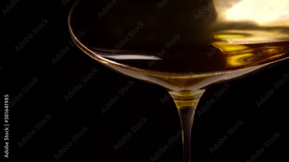 Drop of olive oil drips from the spoon. Drop of olive oil drips from the spoon.