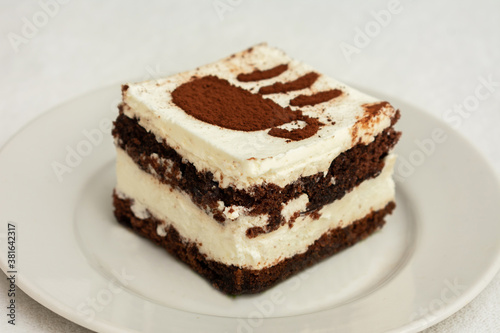 Slice tiramisu cake, drawing in the form of a Cup of coffee, top view, closeup