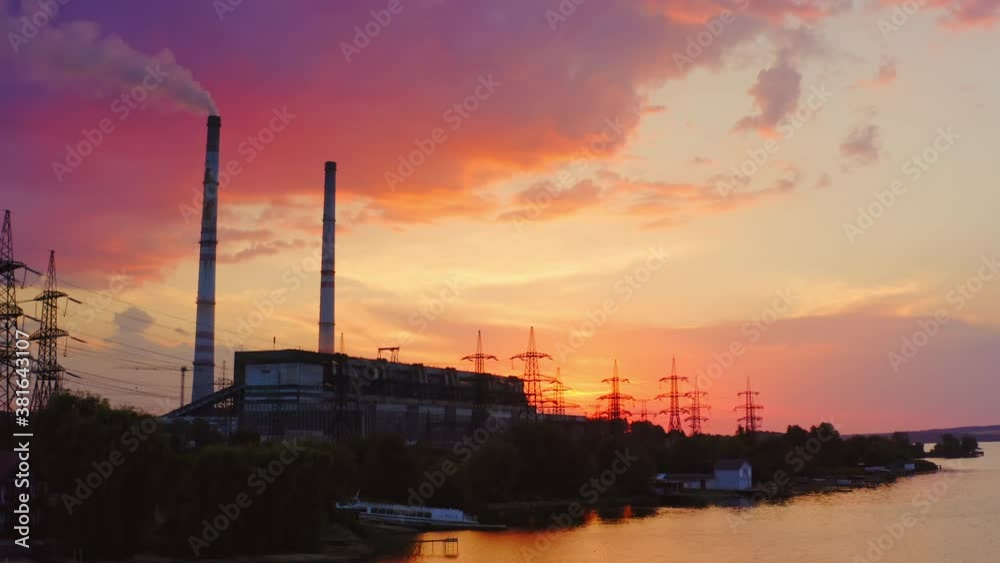 Beautiful sunset with power plant on front view. Red and yellow sky above river. Video. Beautiful sunset with power plant on front view. Red and yellow sky above river. Video.