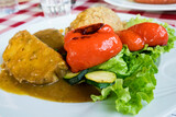Traditional Slovenian dish - Pork steak baked in a thick hot sauce in traditional Austrian style and served with grilled vegetables and mashed potato puree