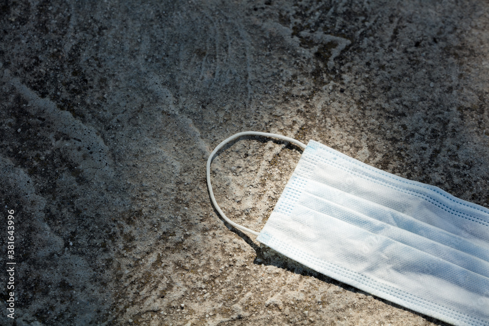 Medical protection mask lost on the ground was used. Disposable mask lying on the street. Incorrectly discarding the used face mask
Medical protection mask lost on the ground was used. Disposable mask lying on the street. Incorrectly discarding the used face mask