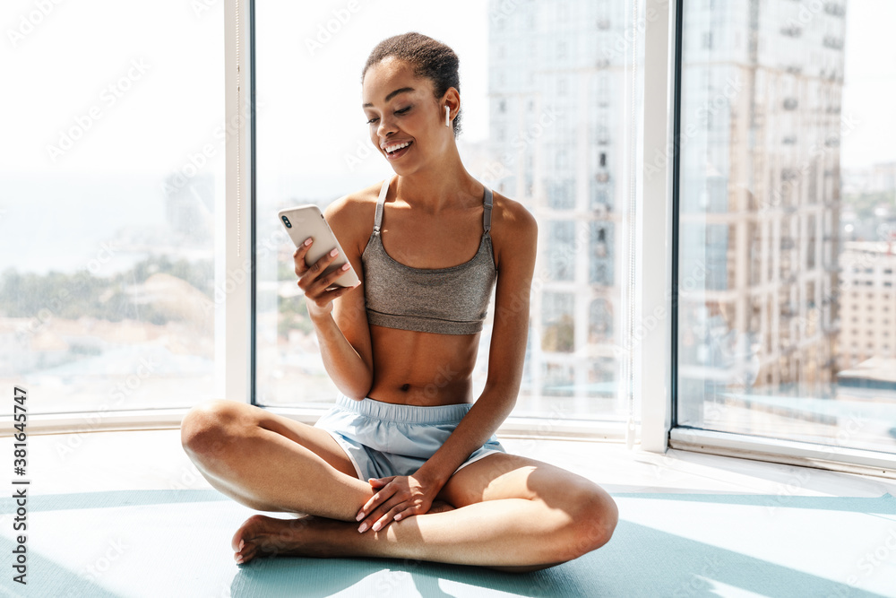 Happy sports african woman using mobile phone Happy sports african woman using mobile phone