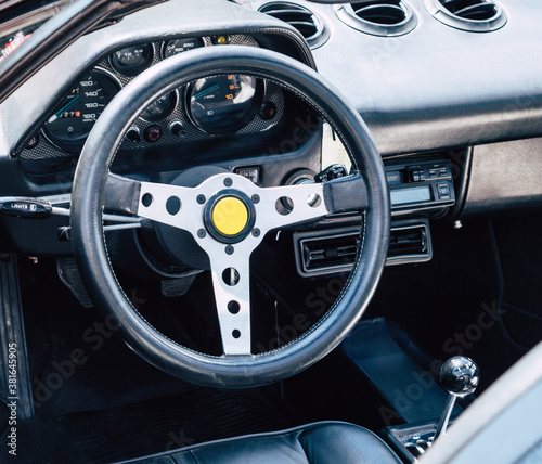 The steering wheel and dashboard of an antique classic car
