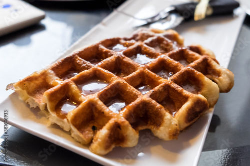 Delicious Belgian waffles with caramel and chocolate topping in the confectionary of Ljubljana, Slovenia