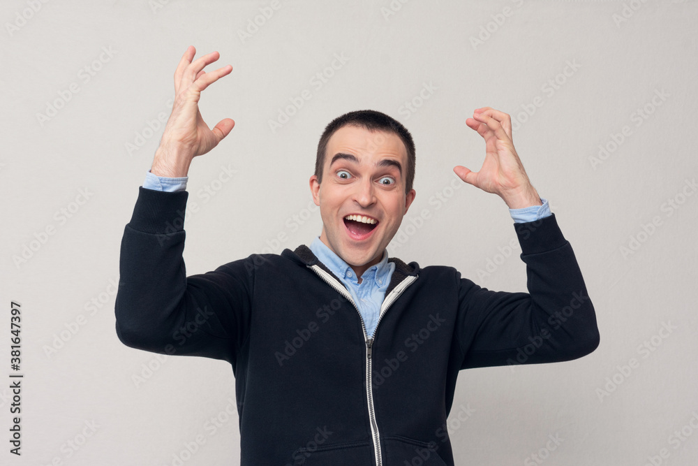 Excited young man shouts: Yes! White background Excited young man shouts: Yes! White background